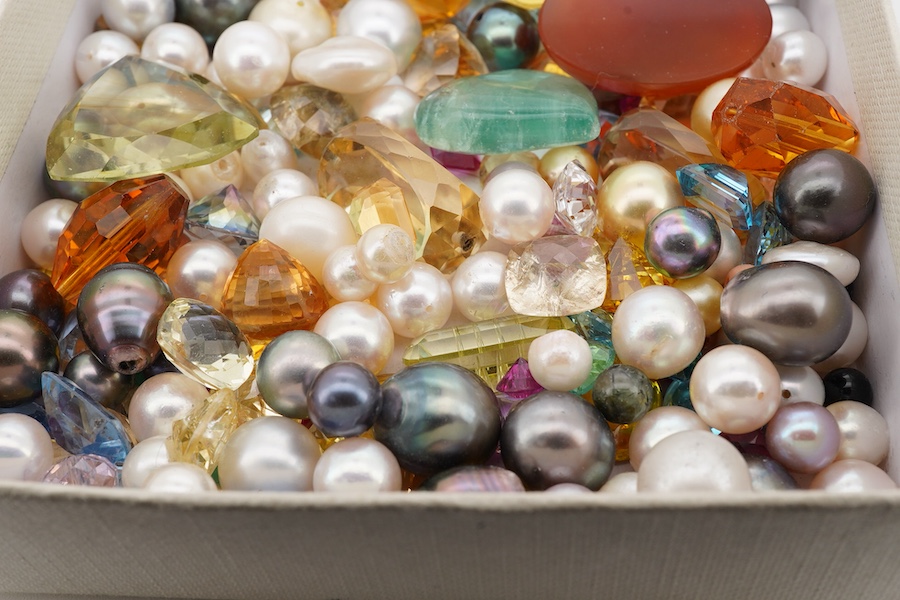 A quantity of assorted loose cultured pearls and unmounted cut gemstones.